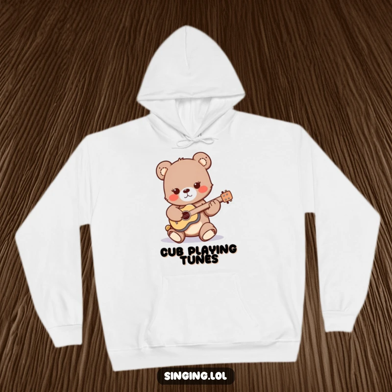 Funny hoodie featuring a playful bear cub strumming a miniature guitar, offering warmth and a touch of adorable rock and roll.